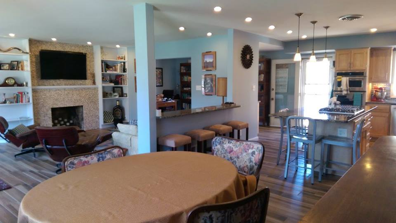 This oval-shaped dining room table and floral chairs got sold and replaced with an original mid-century modern dining room table since this was taken.